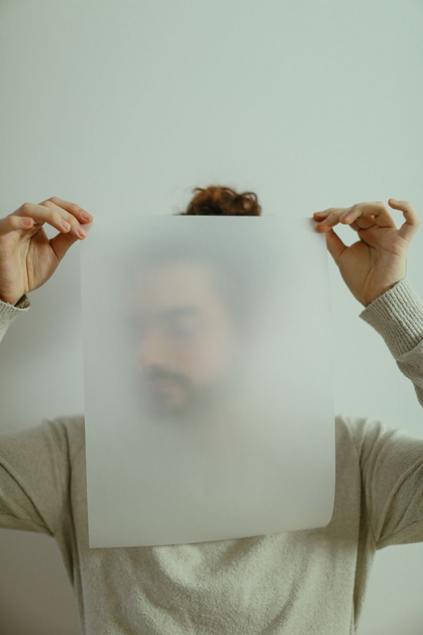 a man holding a thin piece of paper