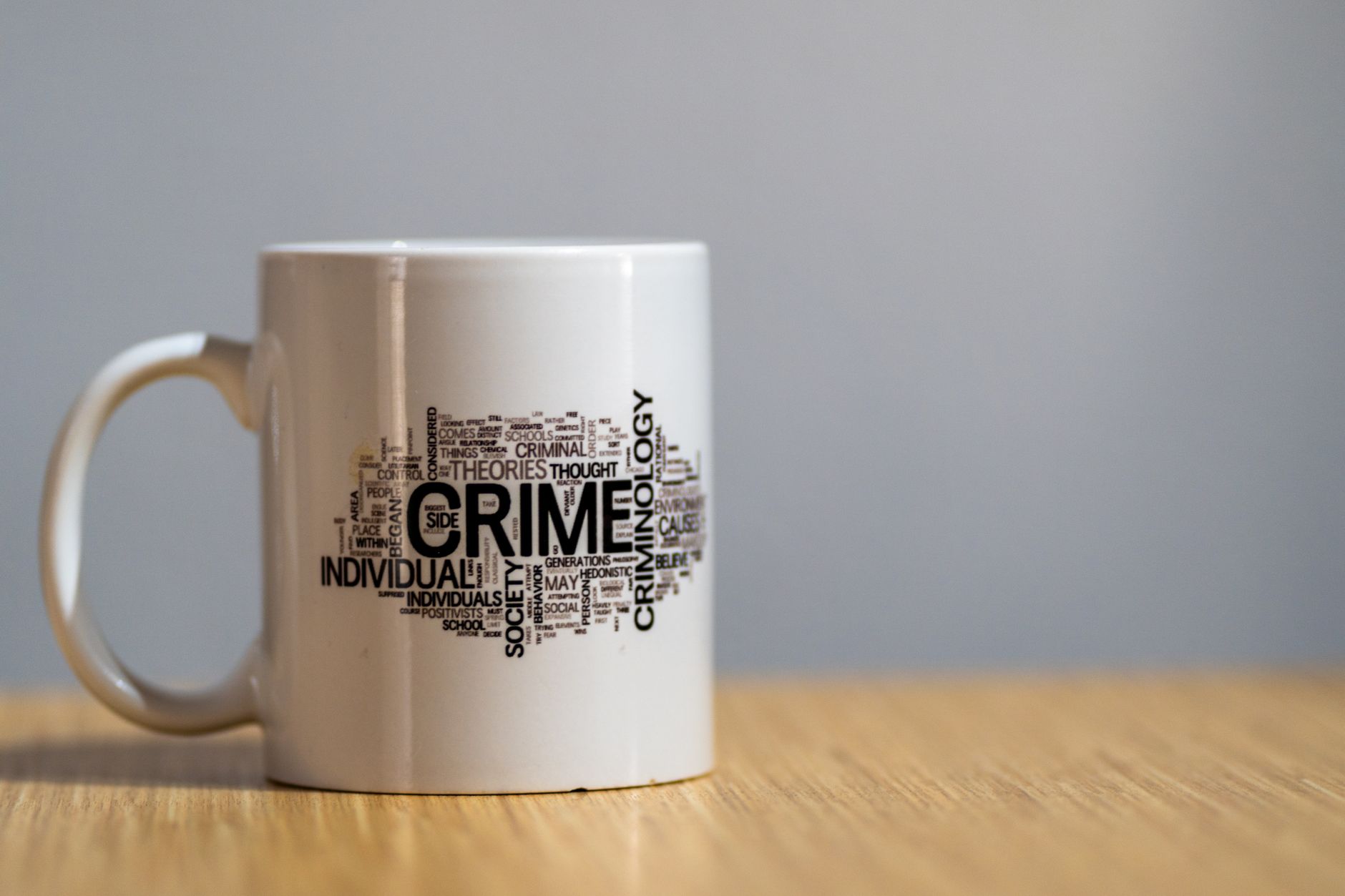 white mug with criminology word cloud design
